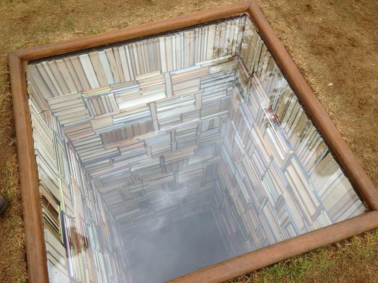 As her entry into Denmark's Sculpture by the Sea, Susanna Hesselberg installed this library falling into the abyss http://t.co/BKxXeMkJ7l